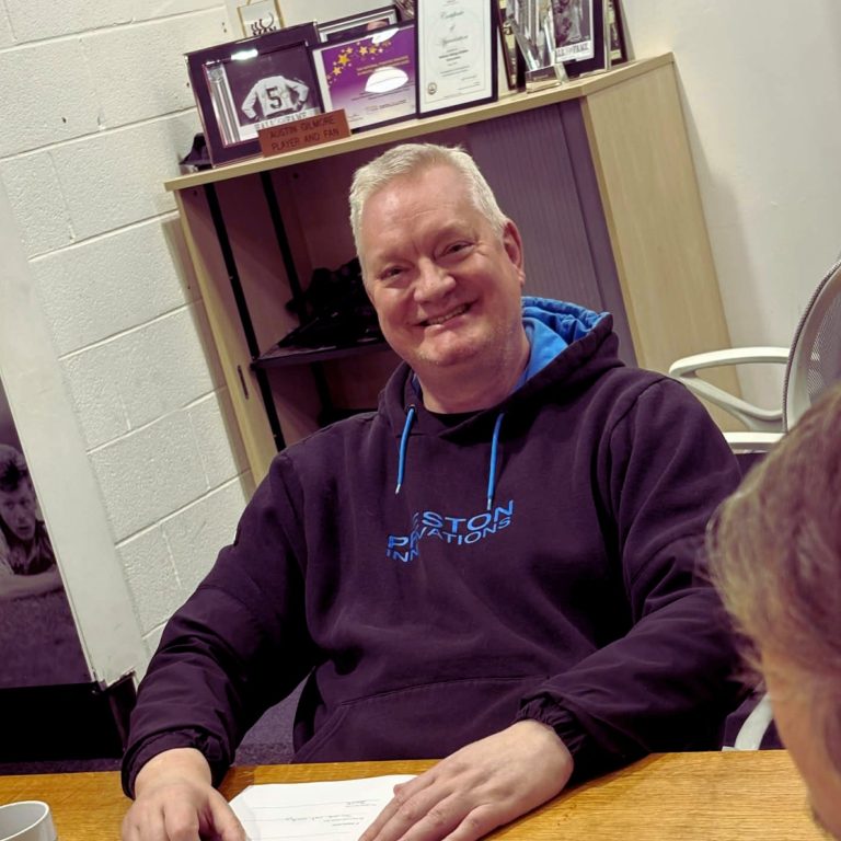 Attendee taking notes during an interactive mental fitness and trauma-informed workshop in Widnes